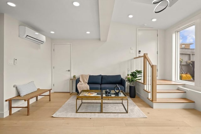 living room with recessed lighting, stairway, an AC wall unit, and wood finished floors