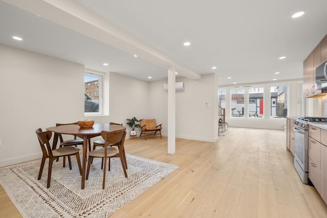 dining area with light wood finished floors, a wall mounted AC, and recessed lighting