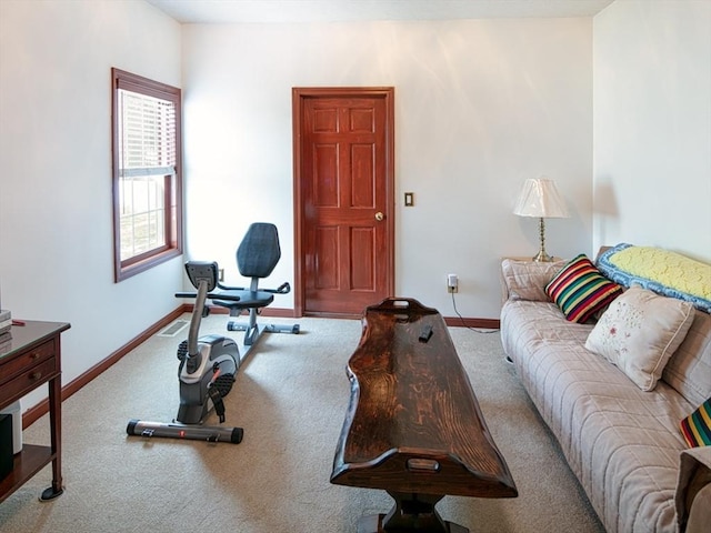 carpeted living area with baseboards