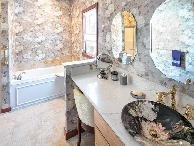 full bathroom featuring tile patterned floors, a garden tub, vanity, and wallpapered walls