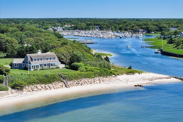 birds eye view of property with a water view and a view of trees