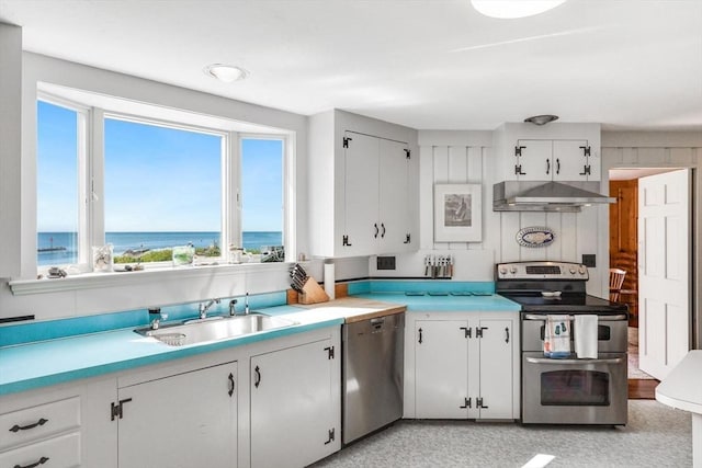 kitchen with stainless steel appliances, light countertops, under cabinet range hood, white cabinetry, and a sink