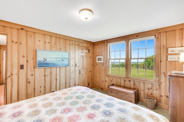 bedroom featuring wood walls