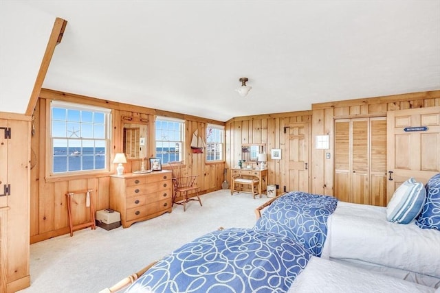 bedroom with carpet flooring and wooden walls