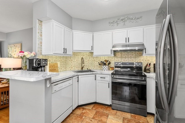 750 Whittenton St Unit 1012, Taunton, MA 02780 - kitchen featuring stainless steel appliances, under cabinet range hood, a sink, backsplash, and white cabinetry