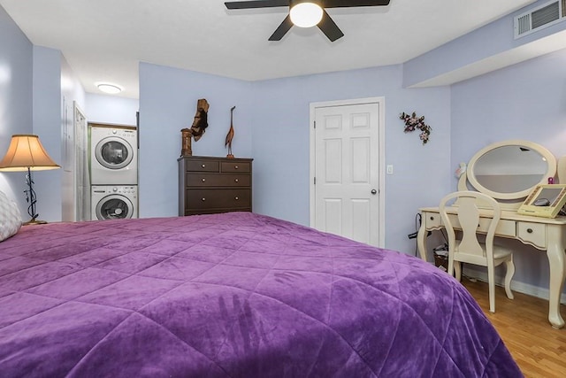 750 Whittenton St Unit 1012, Taunton, MA 02780 - bedroom with estacked washer and dryer, wood finished floors, and ceiling fan