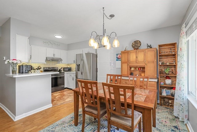 750 Whittenton St Unit 1012, Taunton, MA 02780 - dining space featuring light wood finished floors and a chandelier