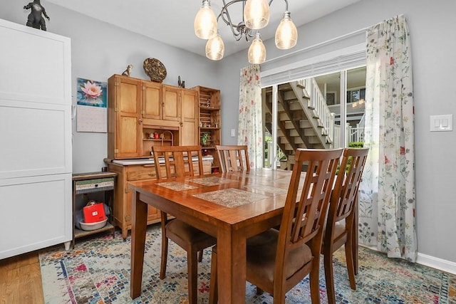 750 Whittenton St Unit 1012, Taunton, MA 02780 - dining space featuring a chandelier, wood finished floors, baseboards, and stairs
