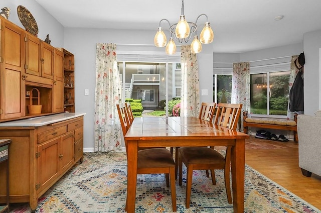750 Whittenton St Unit 1012, Taunton, MA 02780 - dining room with light wood-style floors, a chandelier, and baseboards