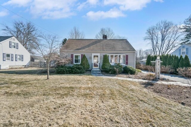 view of front of house featuring a front lawn and a chimney