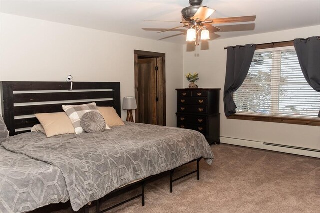 bedroom featuring ceiling fan, baseboard heating, and carpet