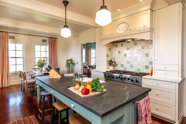25 Lelands Path, Edgartown, MA 02539 - kitchen featuring high end stainless steel range oven, dark wood finished floors, backsplash, decorative light fixtures, and dark stone countertops