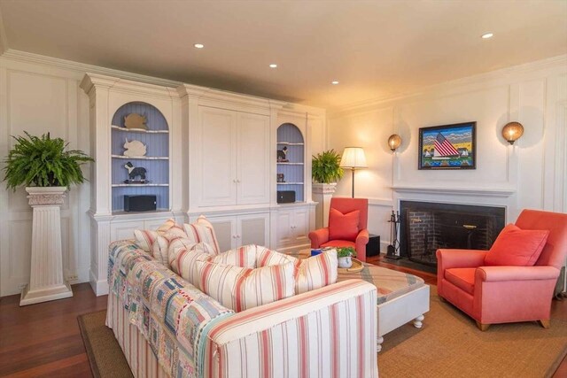 25 Lelands Path, Edgartown, MA 02539 - living area featuring a fireplace with flush hearth, a decorative wall, wood finished floors, recessed lighting, and built in features