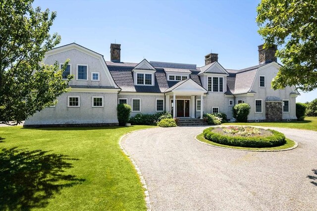 25 Lelands Path, Edgartown, MA 02539 - shingle-style home featuring a chimney, curved driveway, a front yard, and a gambrel roof