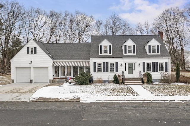 cape cod home featuring a garage