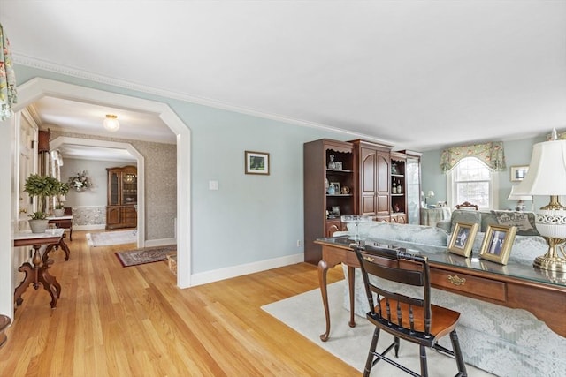 office area featuring light wood-type flooring and crown molding