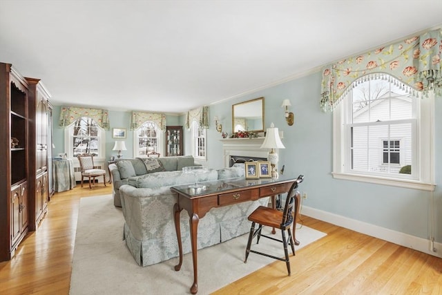 living room featuring light wood-type flooring and ornamental molding