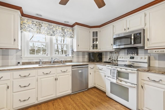 kitchen featuring white cabinets, stainless steel appliances, and light hardwood / wood-style flooring