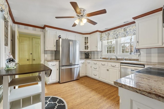 kitchen featuring white cabinets, stainless steel appliances, light wood-type flooring, light stone counters, and crown molding