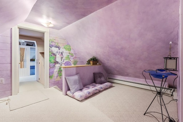 interior space featuring baseboard heating, lofted ceiling, and carpet flooring