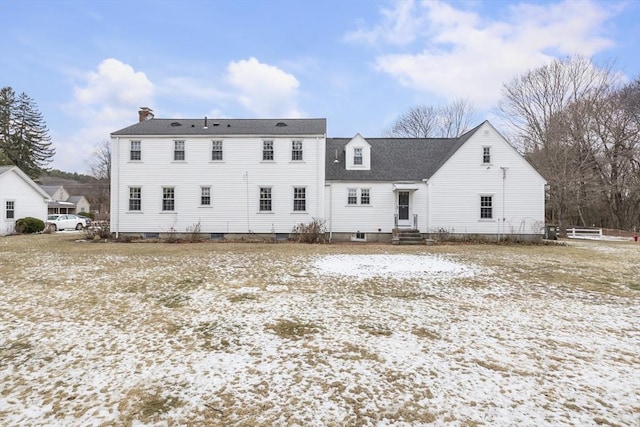 view of snow covered back of property