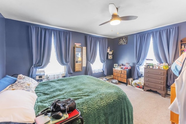 bedroom featuring a baseboard heating unit, carpet floors, and ceiling fan