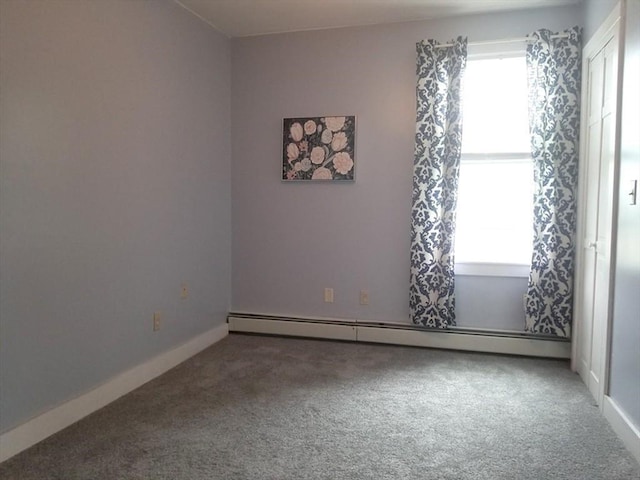 unfurnished room featuring a baseboard radiator and carpet floors