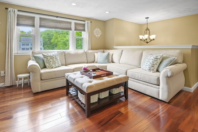 living room featuring a chandelier, hardwood / wood-style floors, recessed lighting, and baseboards