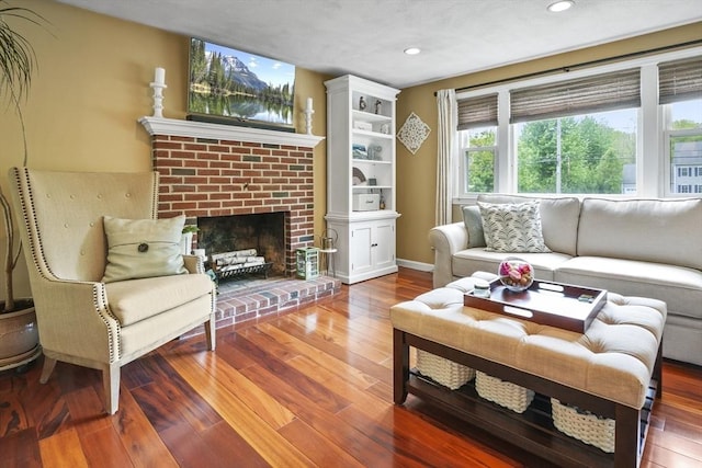 living room with recessed lighting, wood-type flooring, a fireplace, and baseboards