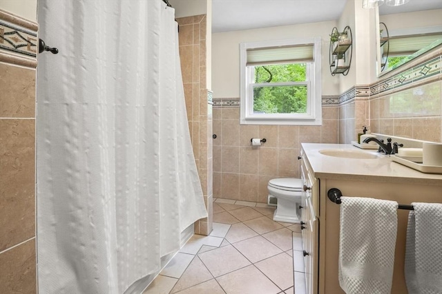 bathroom featuring tile walls, tile patterned flooring, toilet, vanity, and curtained shower