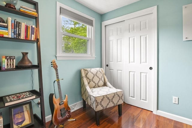 sitting room with baseboards and wood finished floors