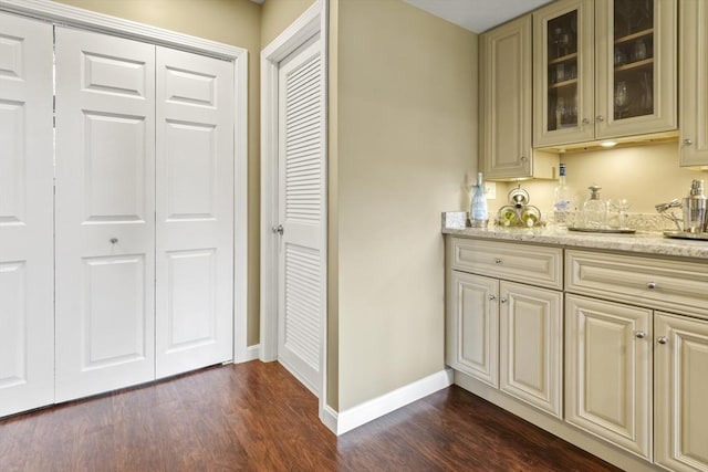 bar featuring dark wood finished floors and baseboards