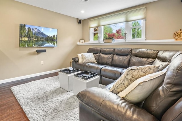 living room featuring baseboards, wood finished floors, and recessed lighting