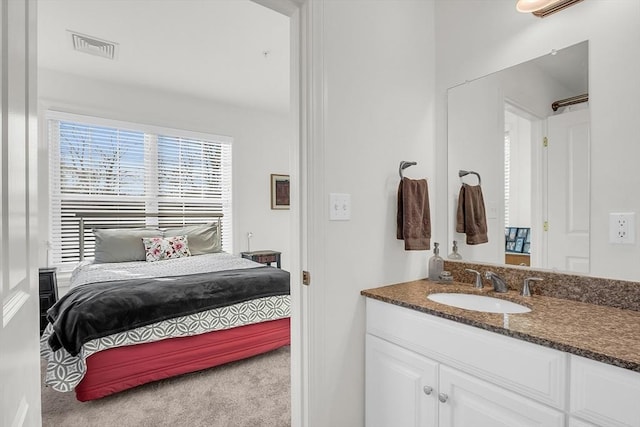 carpeted bedroom featuring sink