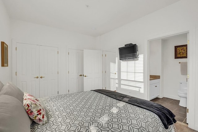 bedroom featuring connected bathroom and light tile patterned floors