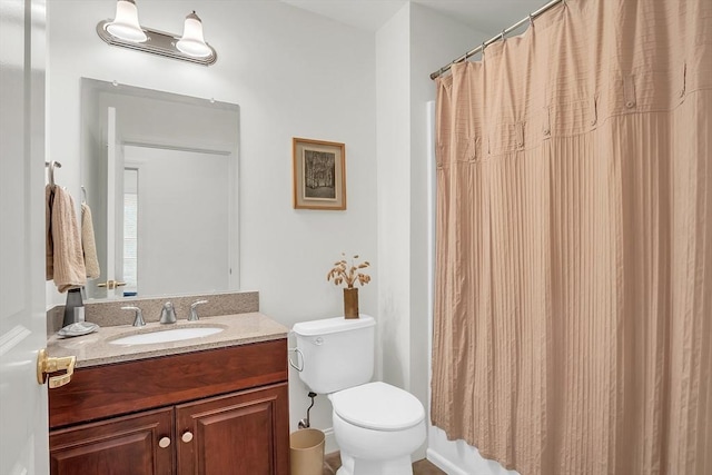 bathroom featuring a shower with curtain, vanity, and toilet