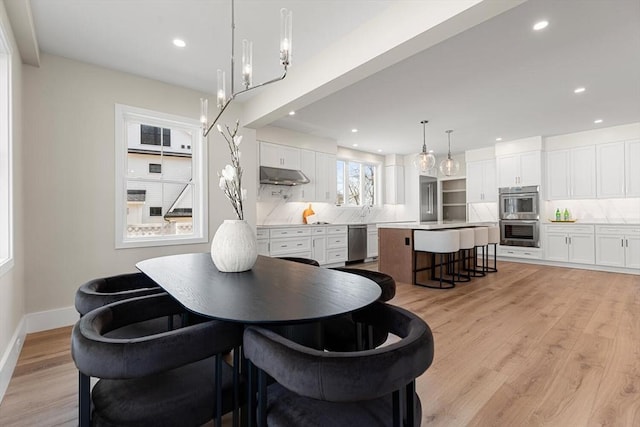 dining room featuring recessed lighting, light wood-type flooring, and baseboards