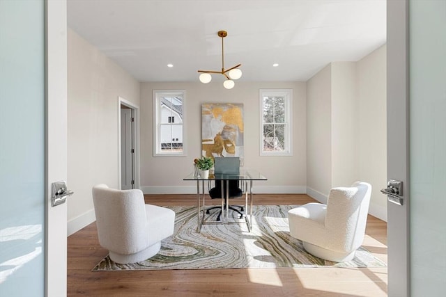 interior space with recessed lighting, baseboards, plenty of natural light, and wood finished floors