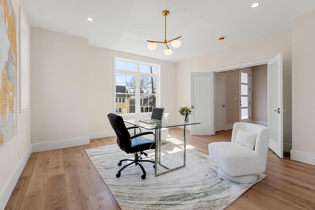 office space featuring an inviting chandelier, recessed lighting, baseboards, and light wood-type flooring