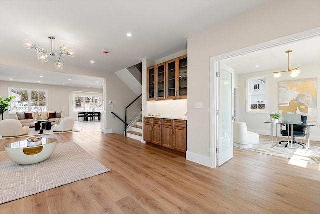 living room with recessed lighting, baseboards, stairs, and light wood-style floors