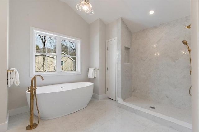 bathroom featuring baseboards, a soaking tub, vaulted ceiling, a walk in shower, and marble finish floor