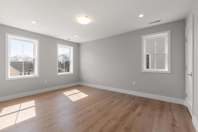 unfurnished room with visible vents, baseboards, and light wood-style floors