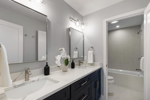 full bath with a sink, toilet, shower / washtub combination, and double vanity