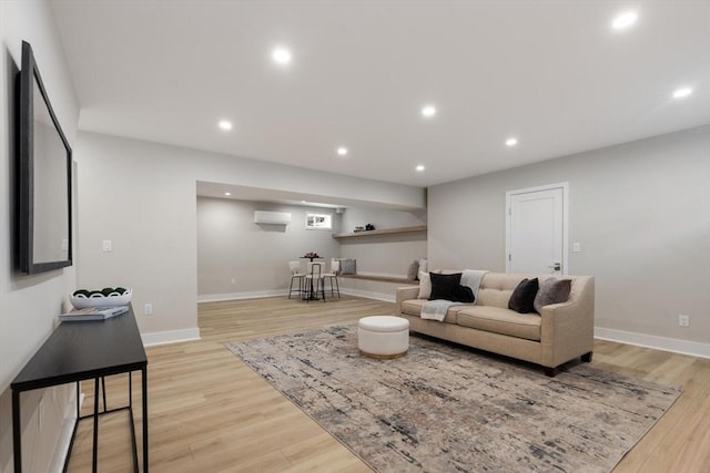 living area featuring recessed lighting, light wood-style floors, and baseboards