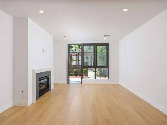 unfurnished living room with light hardwood / wood-style floors