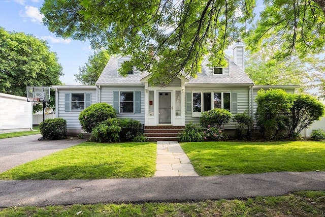 15 University Rd, Arlington, MA 02474 - new england style home featuring a front yard, a chimney, and roof with shingles