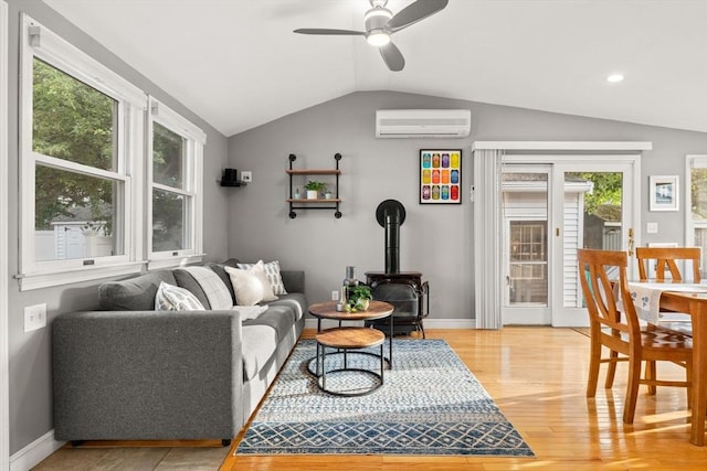 15 University Rd, Arlington, MA 02474 - living room with a wall mounted AC, lofted ceiling, ceiling fan, light wood finished floors, and healthy amount of natural light
