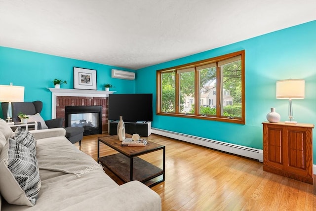 15 University Rd, Arlington, MA 02474 - living area featuring a baseboard heating unit, a wall unit AC, wood finished floors, a brick fireplace, and baseboards