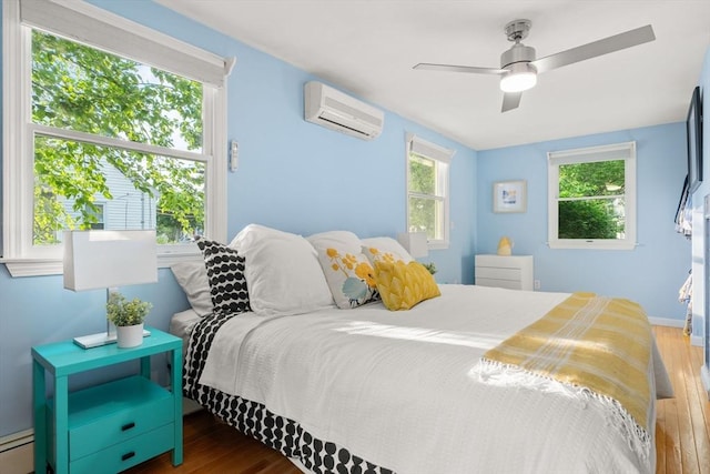15 University Rd, Arlington, MA 02474 - bedroom featuring a wall unit AC, wood finished floors, and multiple windows