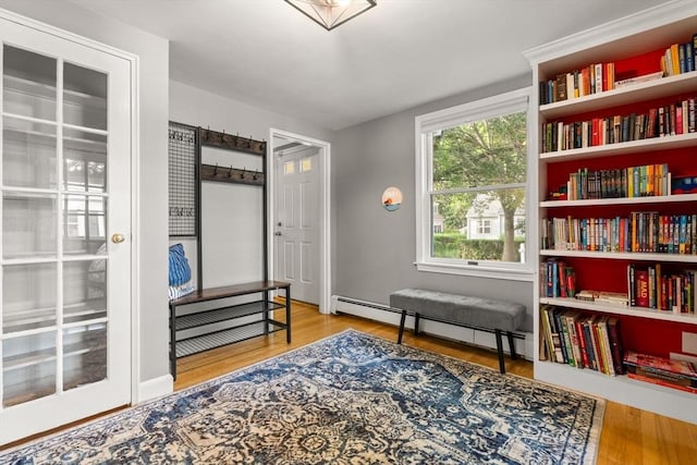 15 University Rd, Arlington, MA 02474 - living area with a baseboard radiator and wood finished floors